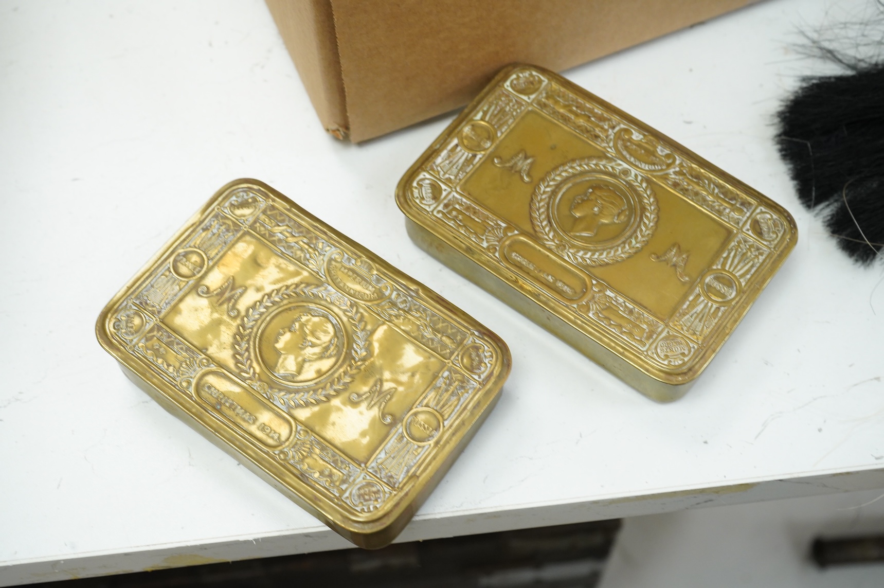 A collection of militaria, etc. including; a Gordon Highlander’s kilt and sporran, three early 20th century Union Flags, a Victorian beaded ‘sweetheart’s’ cushion, two empty First World War Princess Mary Christmas tins,